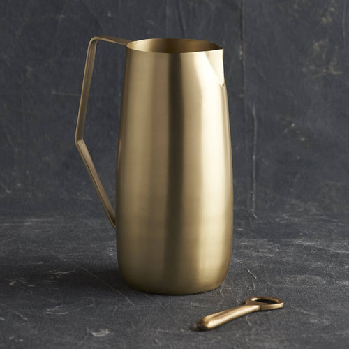 Handcrafted brass pitcher with angled handle and pinched spout, ideal for entertaining and bar decor, 64 oz capacity.