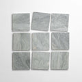 Bardiglio 4x4 tumbled marble tile display, featuring nine light gray tiles arranged in a grid pattern.