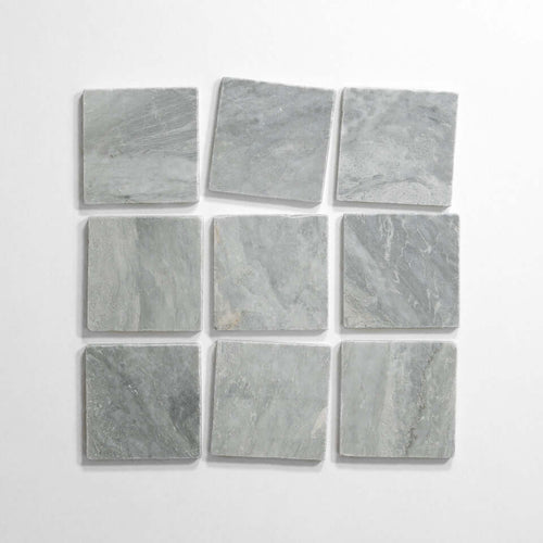 Bardiglio 4x4 tumbled marble tile display, featuring nine light gray tiles arranged in a grid pattern.
