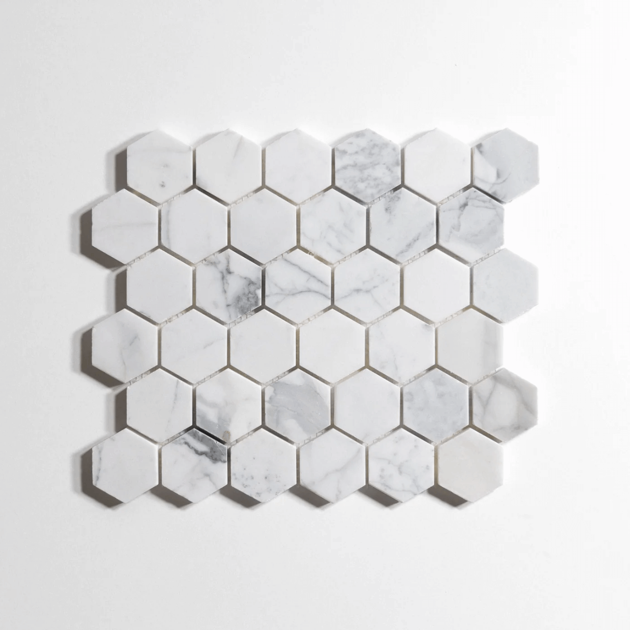 Polished 2" hexagon mosaic tiles in marble finish, 10 sheets per box, ideal for elegant home decor.