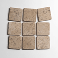 Chocolat 4x4 inch tumbled marble tile, showcasing a group of beige, textured tiles perfect for home decor.